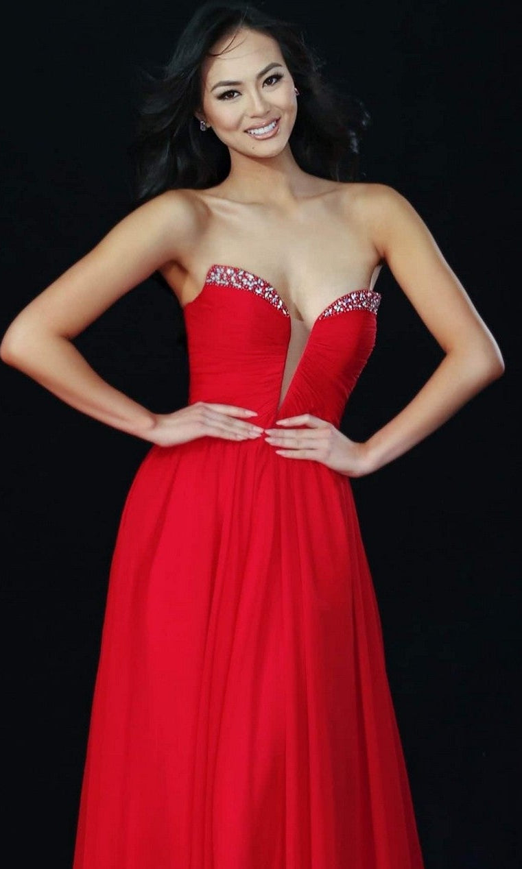 A woman poses against a black background in the Jovani 49422 long prom dress, featuring a strapless sweetheart neckline and jeweled trim.